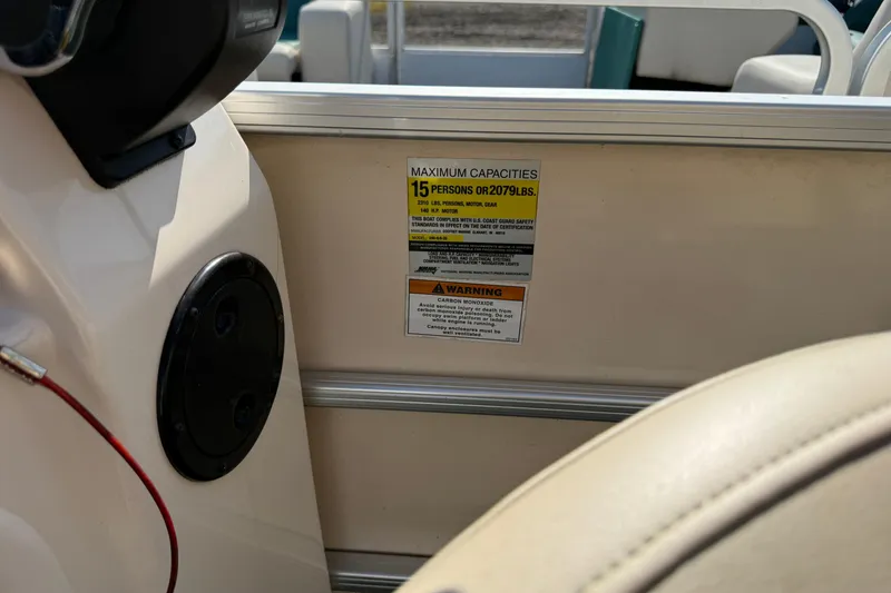 Slide: The Image of 2004 AquaPatio 240RE boat capacity label, seating, and safety warning details. - 26