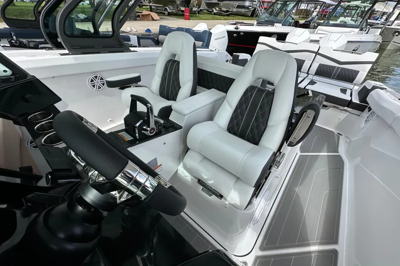 Slide: The Image of 2026 Monterey Elite 30 OB boat interior with modern steering and luxurious seating. - 10