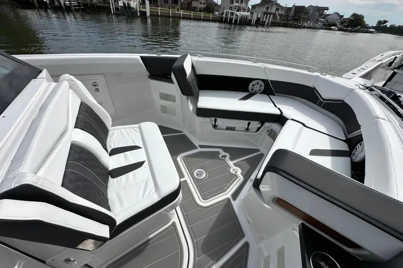 Slide: The Image of Luxurious seating area on a 2026 Monterey Elite 30 OB boat, docked by the water. - 11