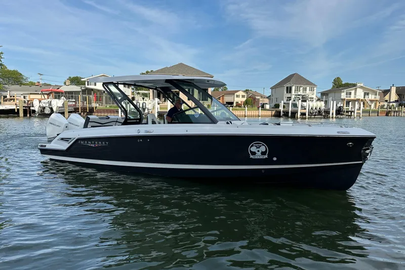 Slide: The Image of 2026 Monterey Elite 30 OB boat on calm water, with modern design and twin Mercury engines. - 4