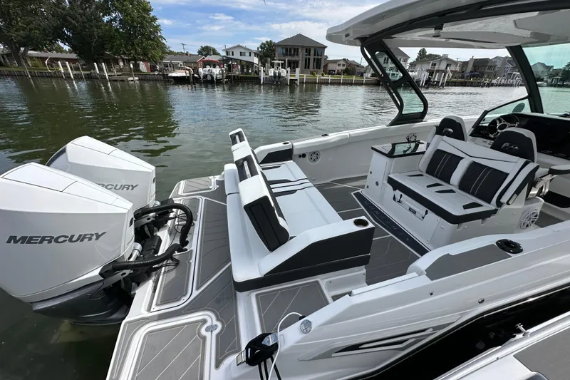 Slide: The Image of 2026 Monterey Elite 30 OB boat with Mercury engines, featuring sleek seating and modern design. - 5