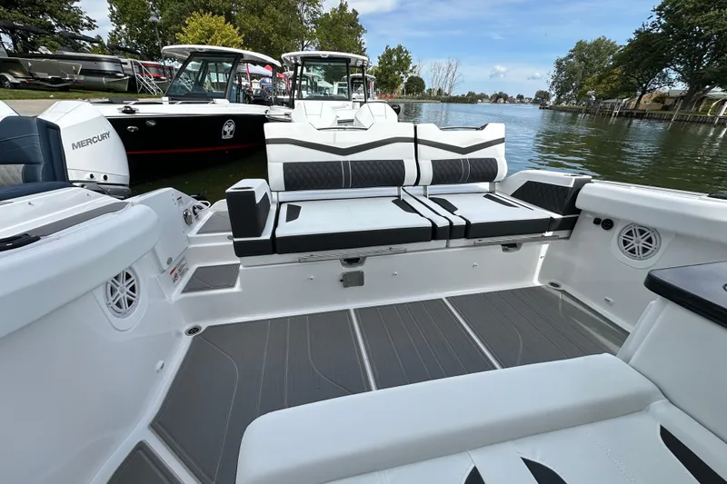 Slide: The Image of 2026 Monterey Elite 30 OB boat interior with sleek seating and modern design on a calm lake. - 7
