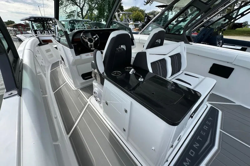 Slide: The Image of 2026 Monterey Elite 30 OB boat interior with sleek seating and modern dashboard design. - 8