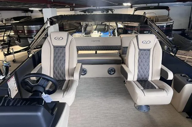 Slide: The Image of 2024 Harris Sunliner 230 boat interior with luxury seating and steering wheel. - 10