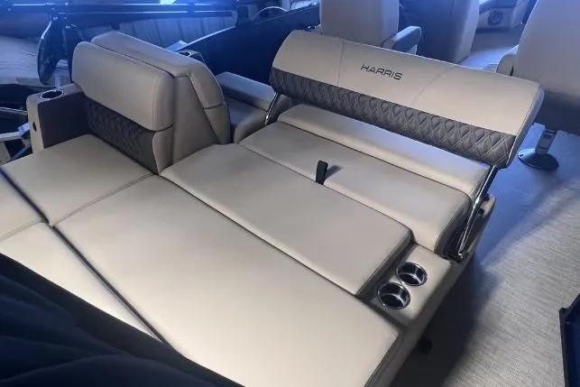 Slide: The Image of 2024 Harris Sunliner 230 boat interior with luxurious seating and cup holders. - 19