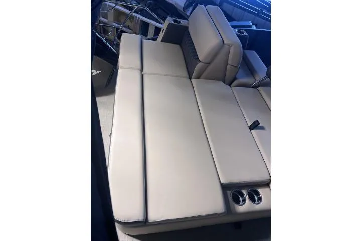 Slide: The Image of 2024 Harris Sunliner 230 boat interior with beige seating and cup holders. - 20