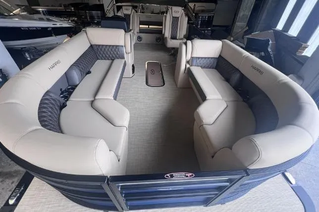 Slide: The Image of 2024 Harris Sunliner 230 pontoon boat with spacious seating and modern interior design. - 6