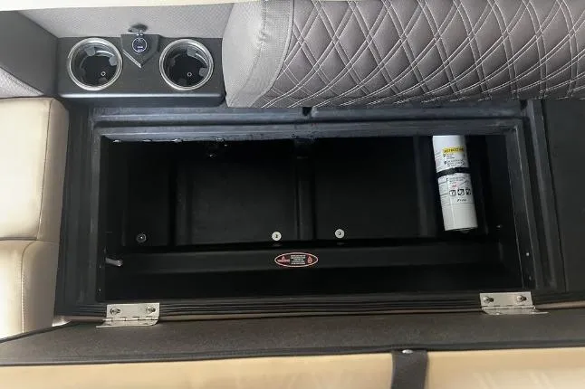 Slide: The Image of 2024 Harris Sunliner 230 storage compartment with cup holders and fire extinguisher. - 8