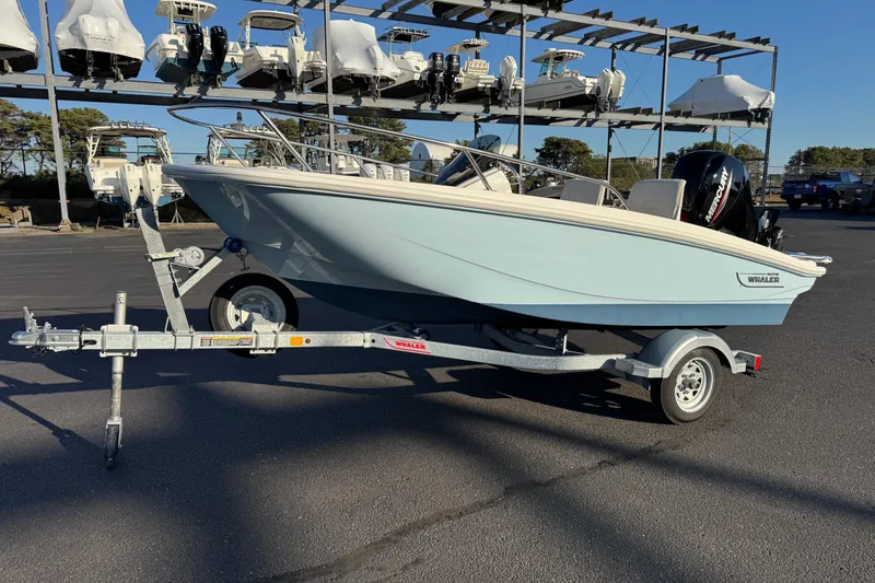 The Image of 2024 Boston Whaler 130 Super Sport boat on trailer in marina setting. - 1