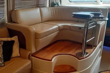 Slide: The Image of Luxurious interior of 2005 Sea Ray 420 Sedan Bridge with leather seating and wooden flooring. - 13