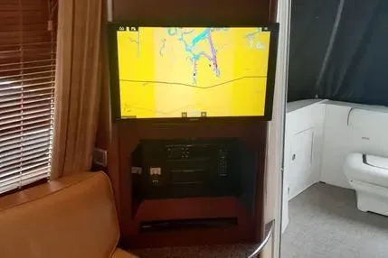 Slide: The Image of Interior of 2005 Sea Ray 420 Sedan Bridge with navigation screen and seating area. - 15