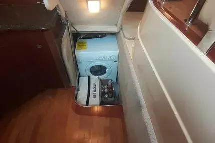 Slide: The Image of 2005 Sea Ray 420 Sedan Bridge interior with washing machine and storage area. - 16