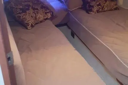 Slide: The Image of 2005 Sea Ray 420 Sedan Bridge cabin with twin beds and decorative pillows. - 18