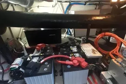 Slide: The Image of Engine room of 2005 Sea Ray 420 Sedan Bridge with batteries and wiring. - 21