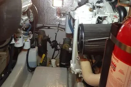 Slide: The Image of Engine room of 2005 Sea Ray 420 Sedan Bridge with visible fire extinguisher and mechanical components. - 24