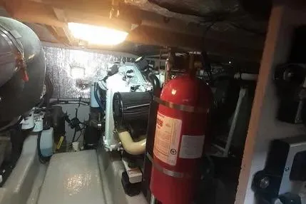 Slide: The Image of Engine room of 2005 Sea Ray 420 Sedan Bridge with fire extinguisher and machinery. - 26