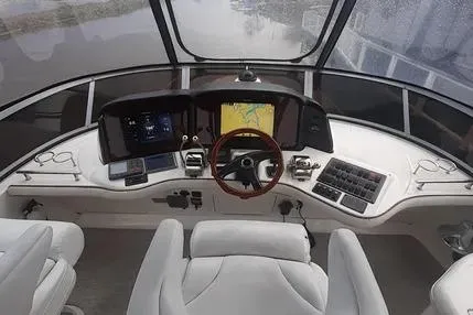 Slide: The Image of 2005 Sea Ray 420 Sedan Bridge helm with navigation screens and steering wheel. - 3