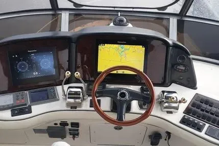Slide: The Image of 2005 Sea Ray 420 Sedan Bridge helm with navigation screens and controls. - 5