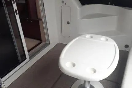 Slide: The Image of 2005 Sea Ray 420 Sedan Bridge interior with table and seating area. - 8