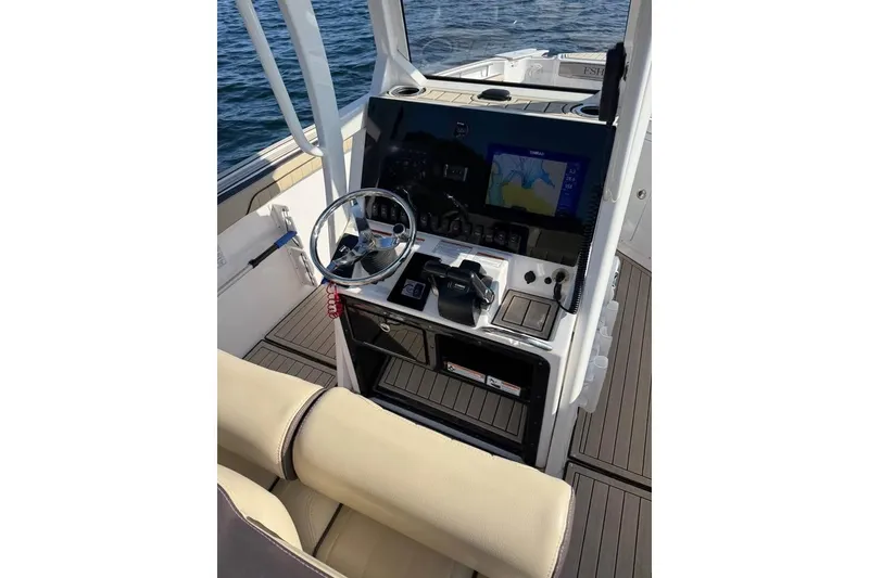 Slide: The Image of 2023 Yamaha 252 FSH boat dashboard with steering wheel and navigation display. - 10