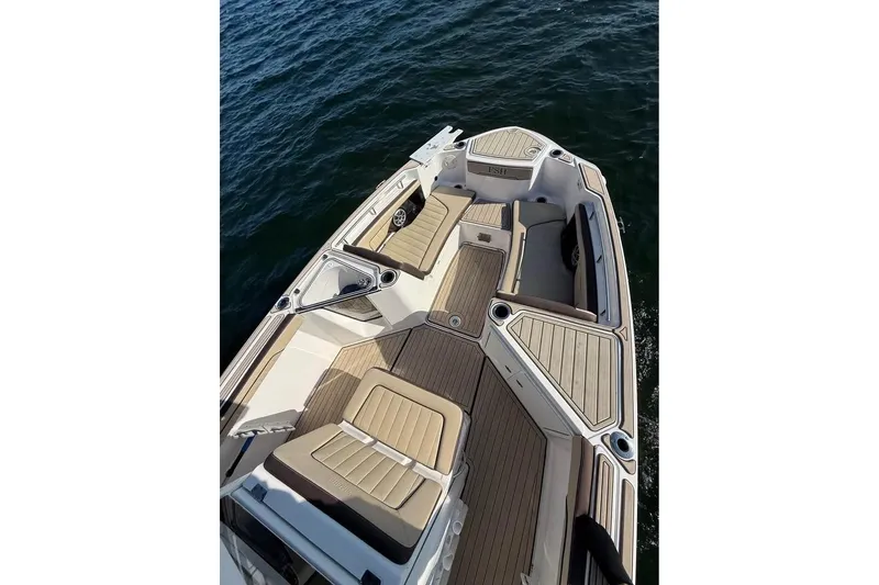 Slide: The Image of 2023 Yamaha 252 FSH boat with spacious deck and seating on the water. - 6