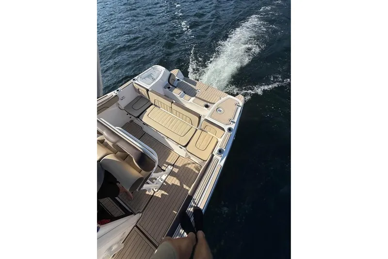 Slide: The Image of 2023 Yamaha 252 FSH boat deck with seating, cruising on water. - 8