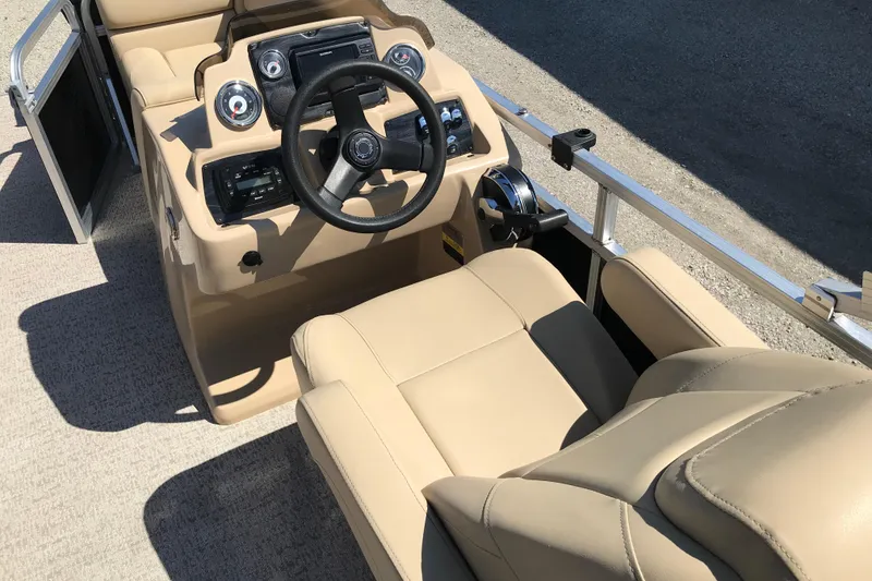 Slide: The Image of 2019 Avalon Venture Fish N Cruise boat interior with beige seating and steering console. - 13