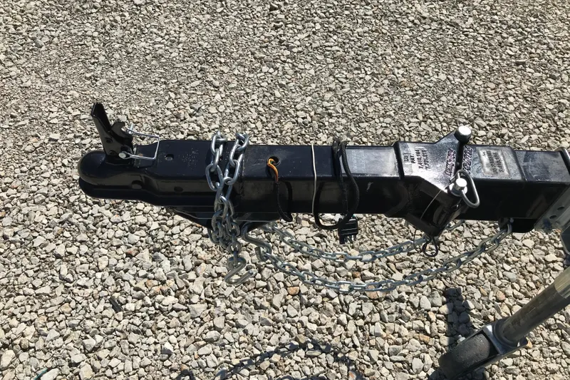 Slide: The Image of Trailer hitch with chains on gravel, Avalon Venture Fish N Cruise 2019 model. - 19