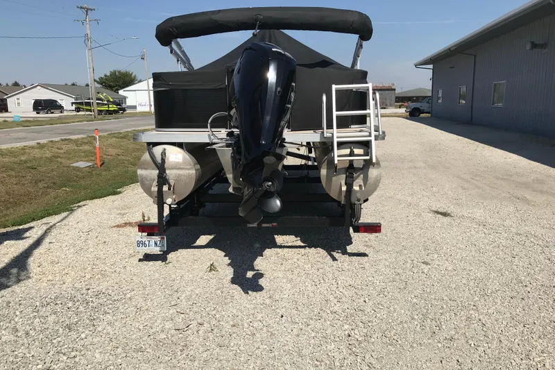 Slide: The Image of 2019 Avalon Venture Fish N Cruise 20' pontoon boat with outboard motor on gravel driveway. - 20