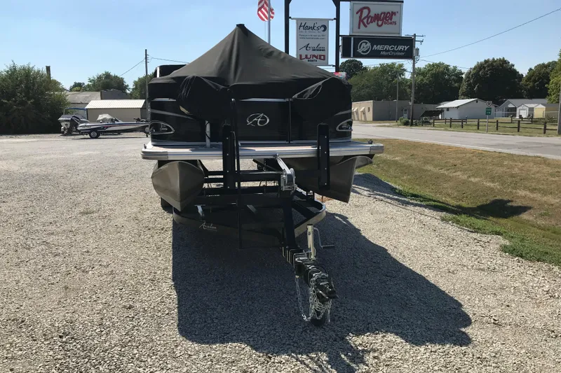 Slide: The Image of 2019 Avalon Venture Fish N Cruise boat on trailer, parked in gravel lot. - 22