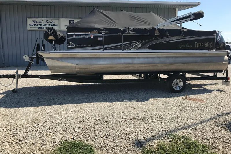 Slide: The Image of 2019 Avalon Venture Fish N Cruise 20' pontoon boat on trailer outside Hank's Sales. - 23