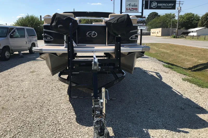 Slide: The Image of 2019 Avalon Venture Fish N Cruise boat on trailer, parked on gravel lot. - 6