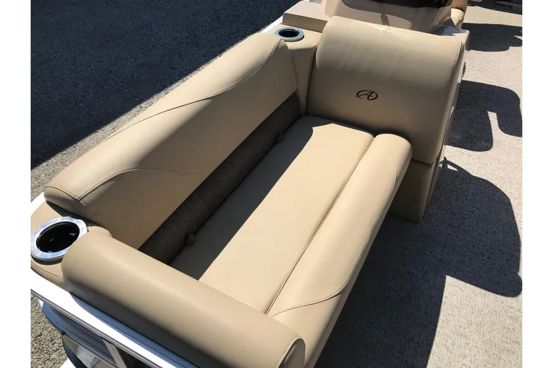 Slide: The Image of 2019 Avalon Venture Fish N Cruise 20' boat with beige seating and cup holders. - 8