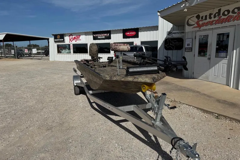 Slide: The Image of 2023 Excel 1751V4M boat on trailer outside Outdoor Specialties store. - 7