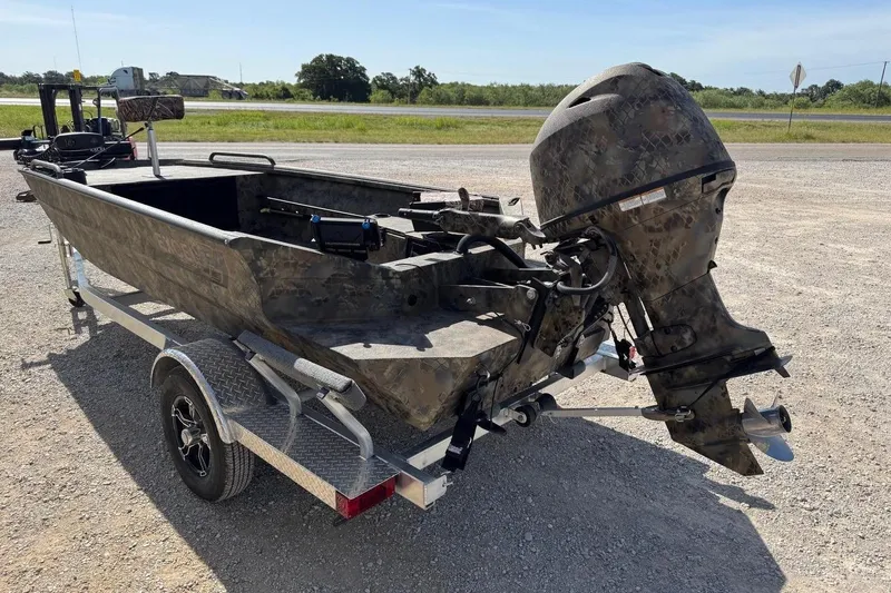 Slide: The Image of 2023 Excel 1751V4M boat with camouflage design on a trailer, parked outdoors. - 3