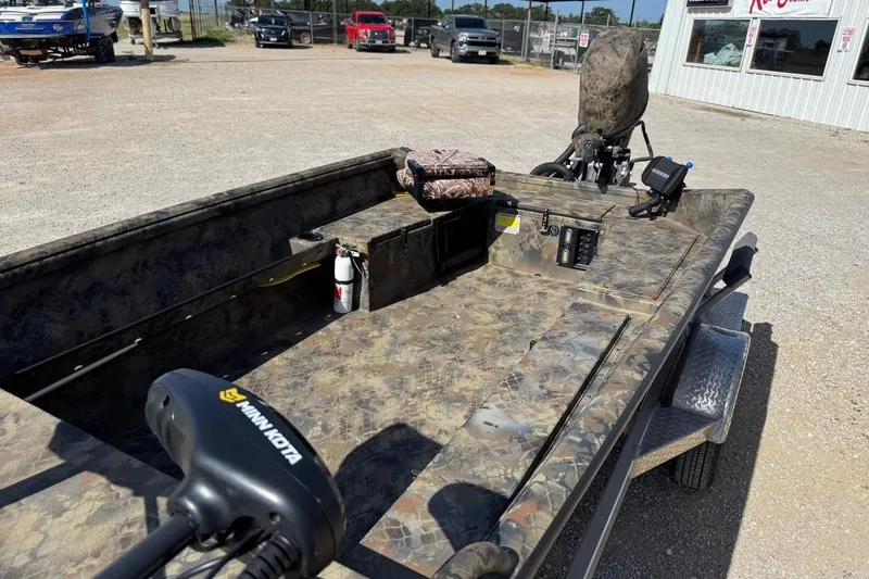 Slide: The Image of 2023 Excel 1751V4M boat with camo design, featuring Minn Kota trolling motor. - 6