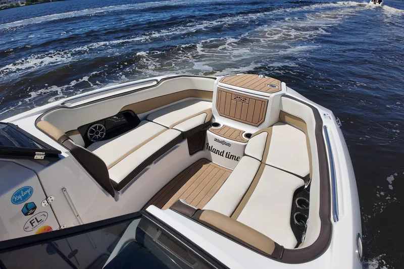 Slide: The Image of 2021 Yamaha Boats 252S interior with cushioned seating on the water. - 15