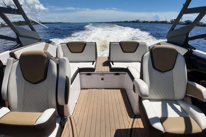 Slide: The Image of 2021 Yamaha Boats 252S interior with luxurious seating on open water. - 16