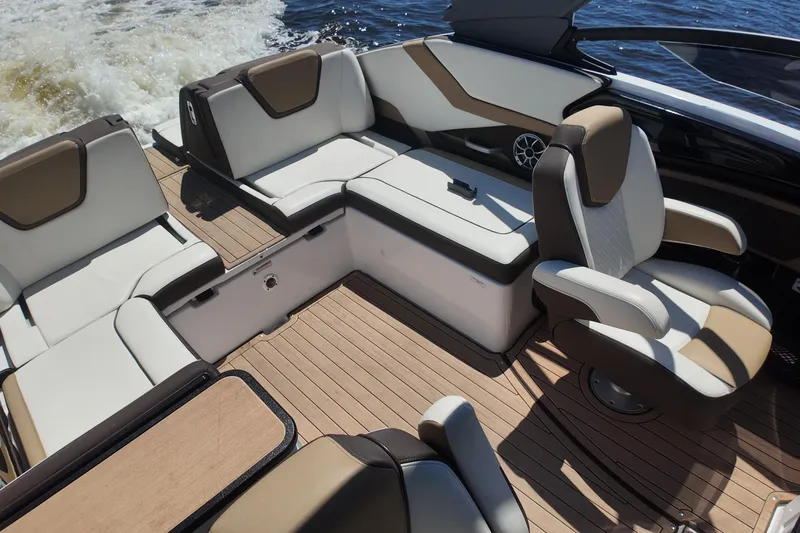 Slide: The Image of 2021 Yamaha Boats 252S interior with luxurious seating and sleek design on the water. - 17