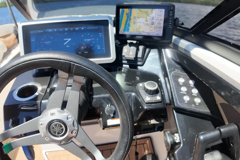 Slide: The Image of 2021 Yamaha Boats 252S dashboard with steering wheel and navigation screens. - 19