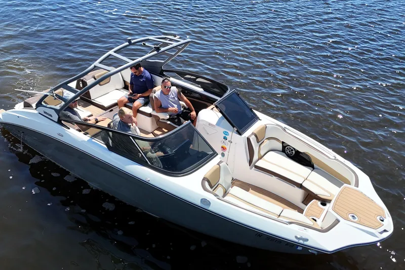 Slide: The Image of 2021 Yamaha Boats 252S on water with passengers enjoying a sunny day. - 2
