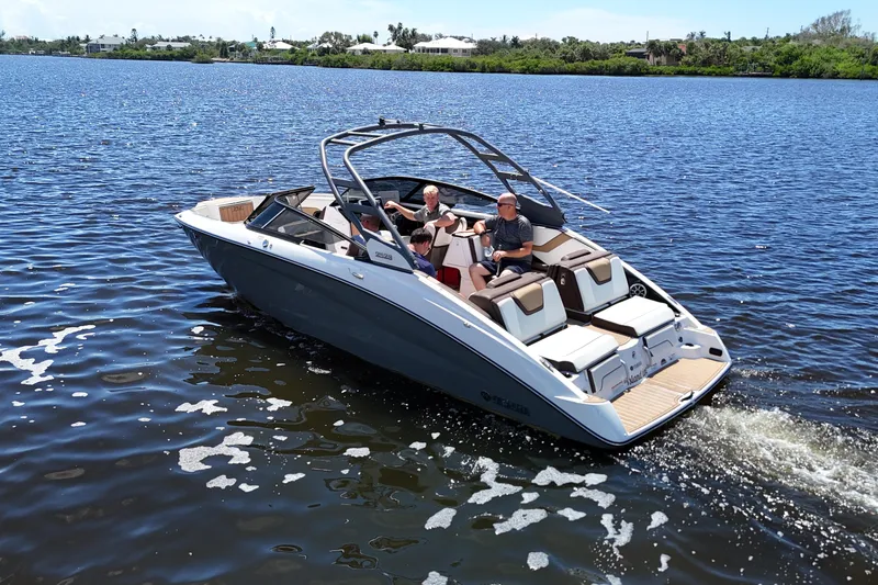 Slide: The Image of 2021 Yamaha Boats 252S cruising on a sunny lake with passengers enjoying the ride. - 24