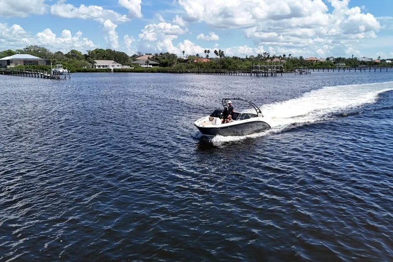 Slide: The Image of 2021 Yamaha Boats 252S cruising on a sunny day in a scenic waterway. - 25