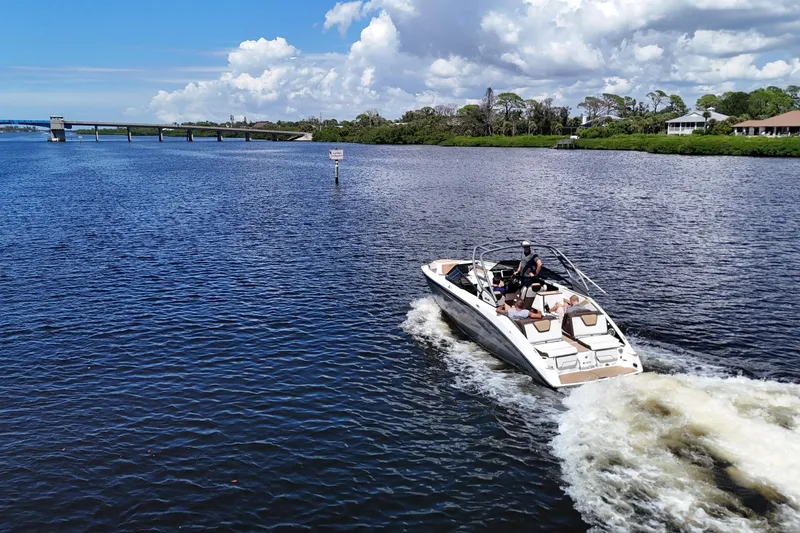 Slide: The Image of 2021 Yamaha Boats 252S cruising on a scenic river under a partly cloudy sky. - 26