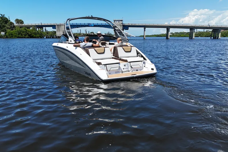 Slide: The Image of 2021 Yamaha Boats 252S cruising on a sunny day near a bridge. - 3