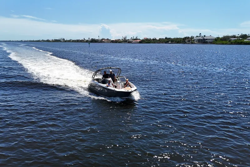 Slide: The Image of 2021 Yamaha Boats 252S cruising on a sunny lake, leaving a wake behind. - 4