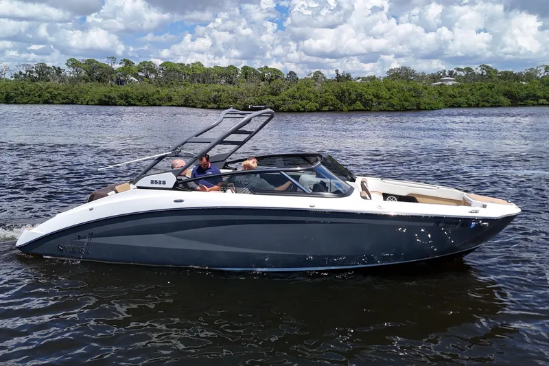 Slide: The Image of 2021 Yamaha Boats 252S cruising on a scenic river under a partly cloudy sky. - 6
