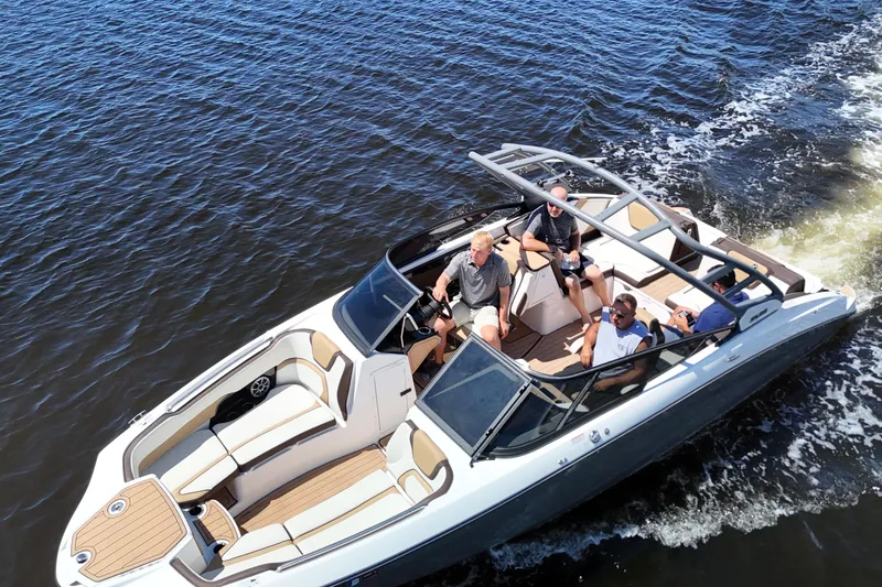 Slide: The Image of 2021 Yamaha Boats 252S cruising on water with passengers enjoying the ride. - 8