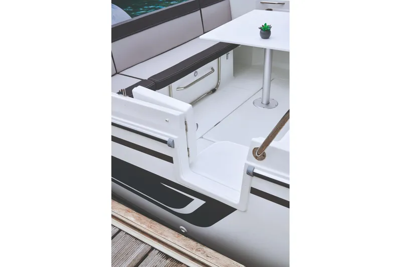 Slide: The Image of 2026 Jeanneau NC 795 Series 2 boat interior with seating and table. - 12