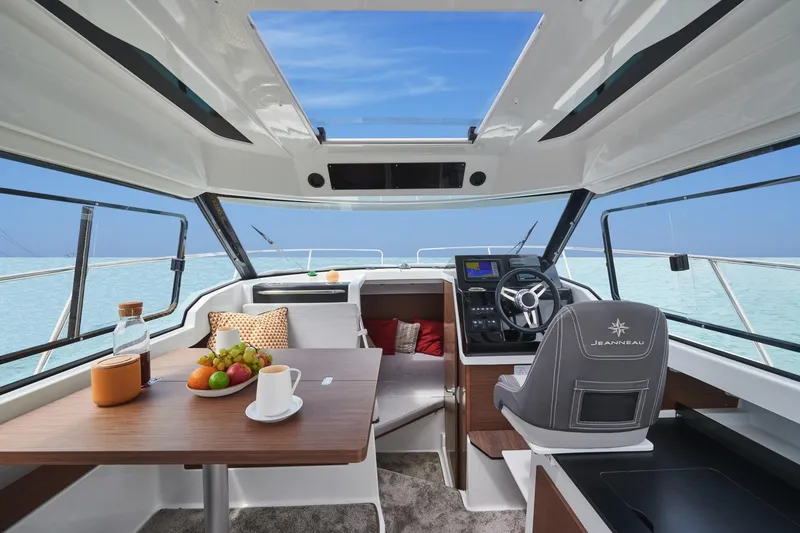 Slide: The Image of Interior of 2026 Jeanneau NC 795 Series 2 boat with dining area and helm. - 5